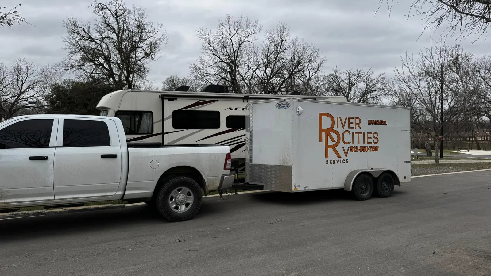 River Cities RV Service truck and lettered trailer headed to a job, mobile RV repair