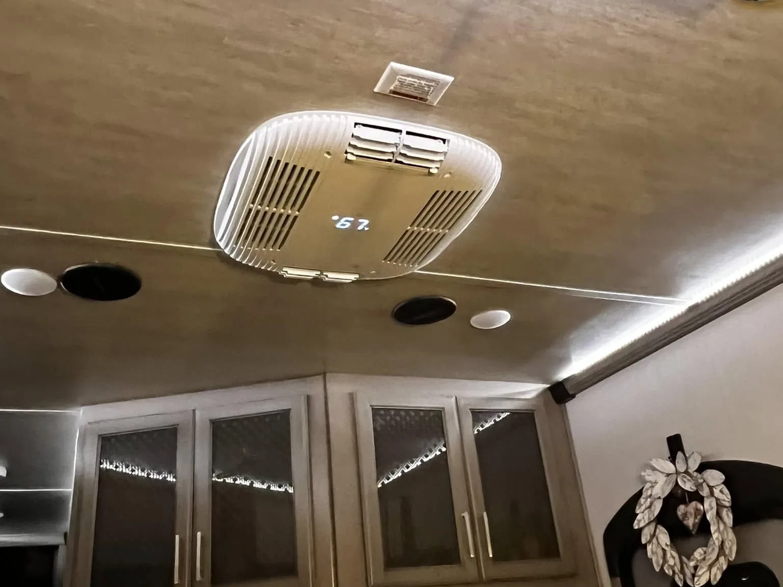 New RV air conditioner ceiling assembly installed over a kitchen, RV AC repair