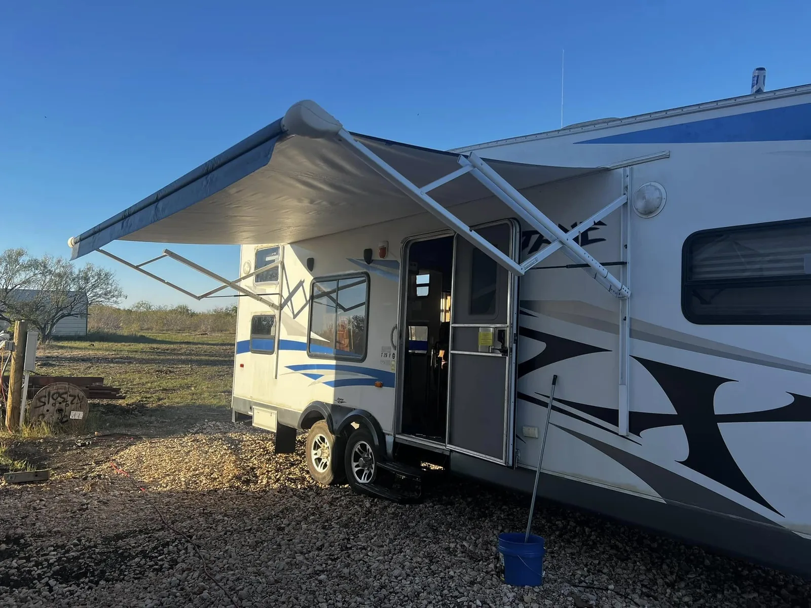 New awning deployed on a travel trailer, RV awning repair and replacement