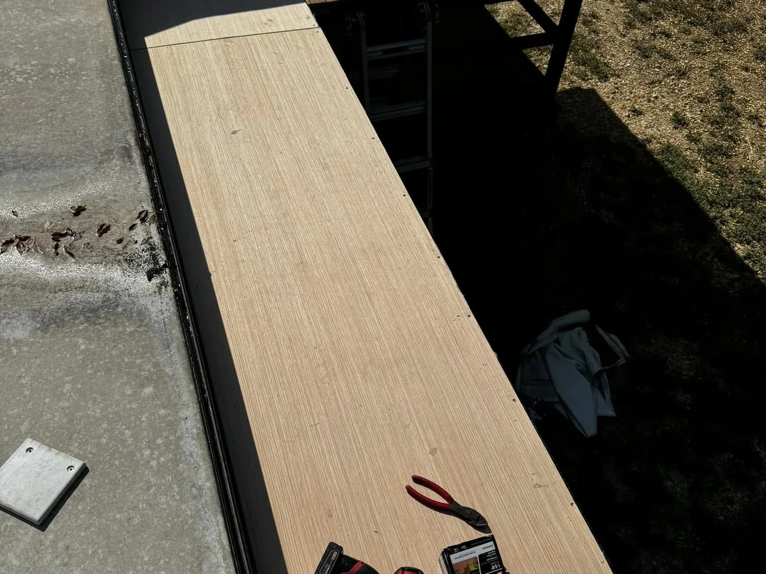 Fifth wheel exterior with a ladder set up for repair, RV collision repair