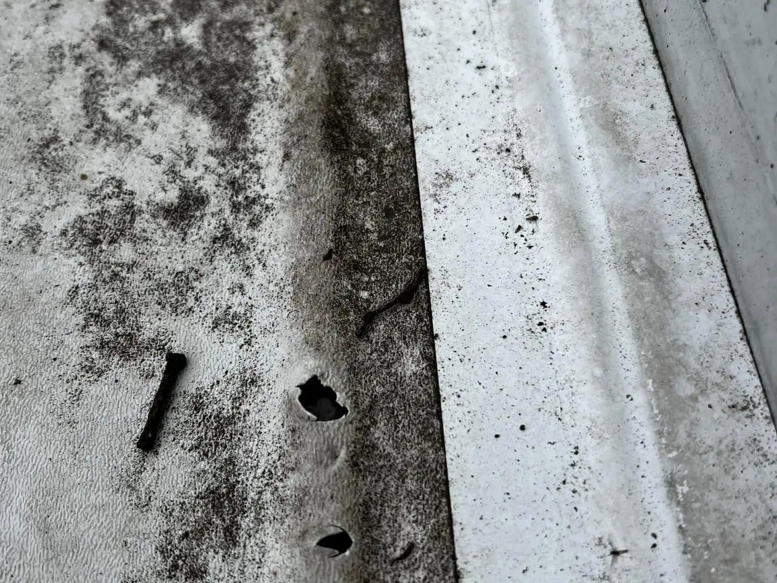 Torn RV roof seam and sidewall edge damage before repair, RV collision repair