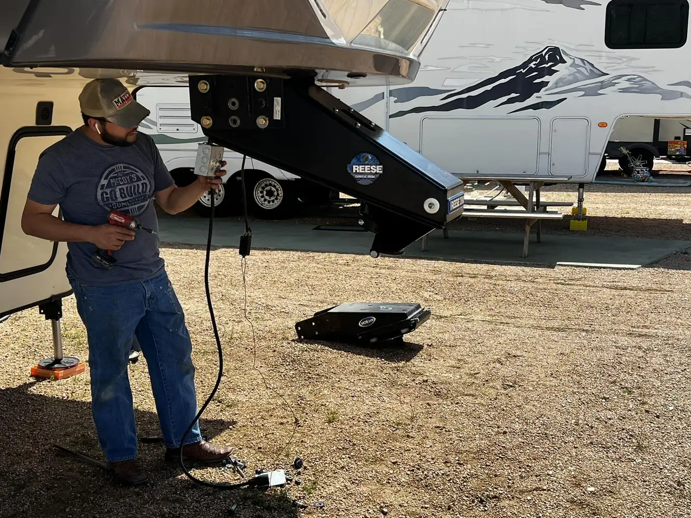 Technician working on fifth wheel landing gear wiring, RV electrical and generator repair