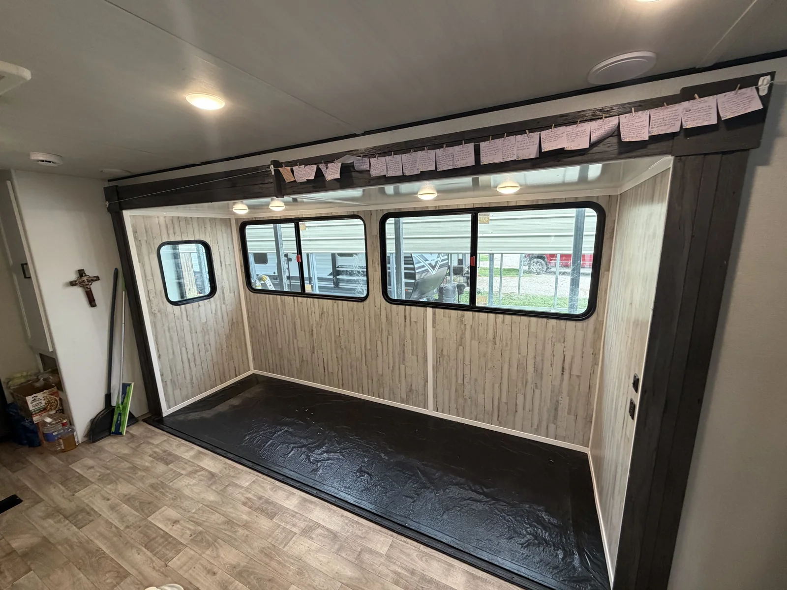 Finished RV interior rebuild with new wall panels, trim and flooring around the windows, RV body repair