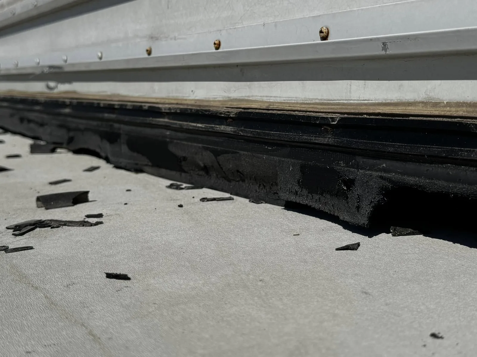 Worn sealant along an RV slide roof edge found during an inspection, RV maintenance