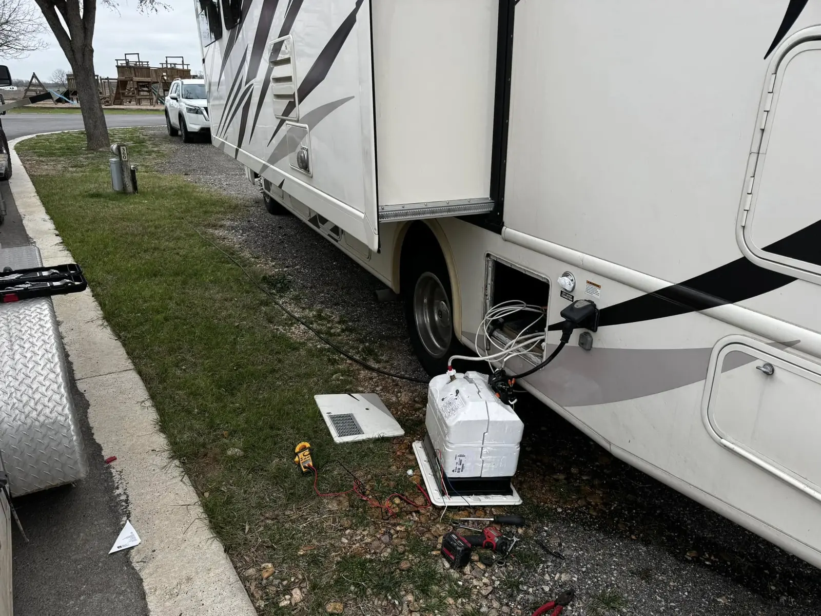Water heater swap at a motorhome parked on a street, RV plumbing and water heater repair