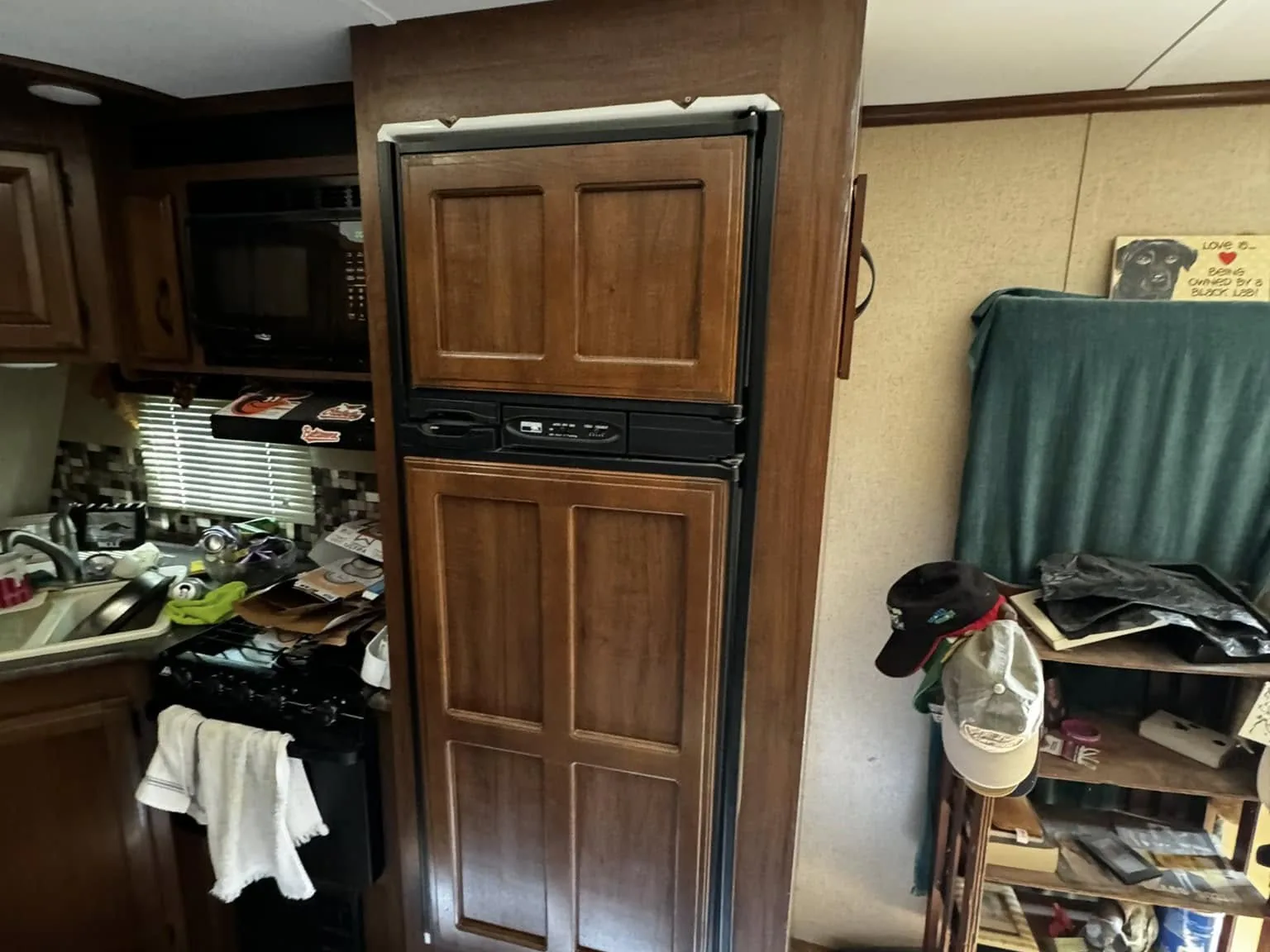 Old RV refrigerator opening in a travel trailer before the new unit goes in, RV refrigerator repair