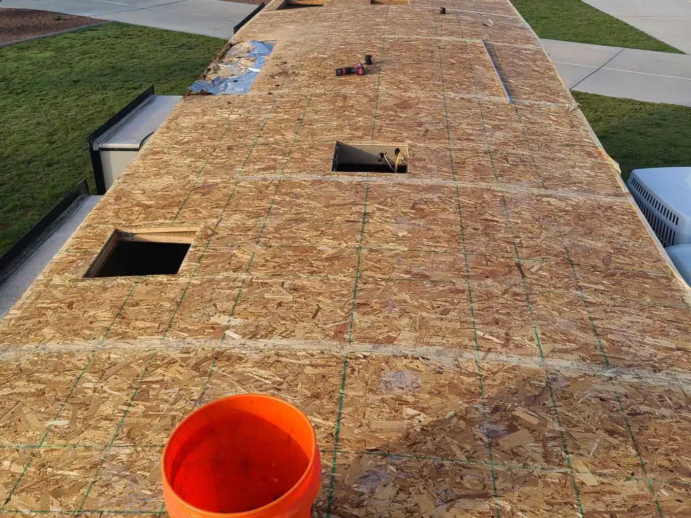 New roof decking with vent openings cut before the membrane goes on, RV roof repair