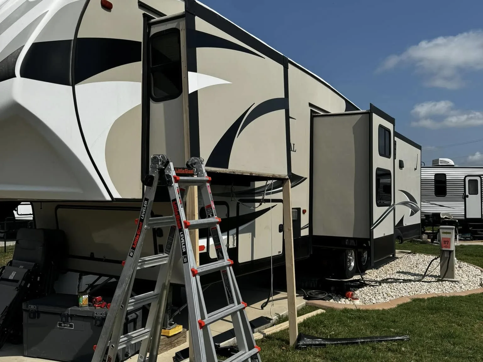 Fifth wheel slide out box with a ladder set up for repair, RV slide out repair