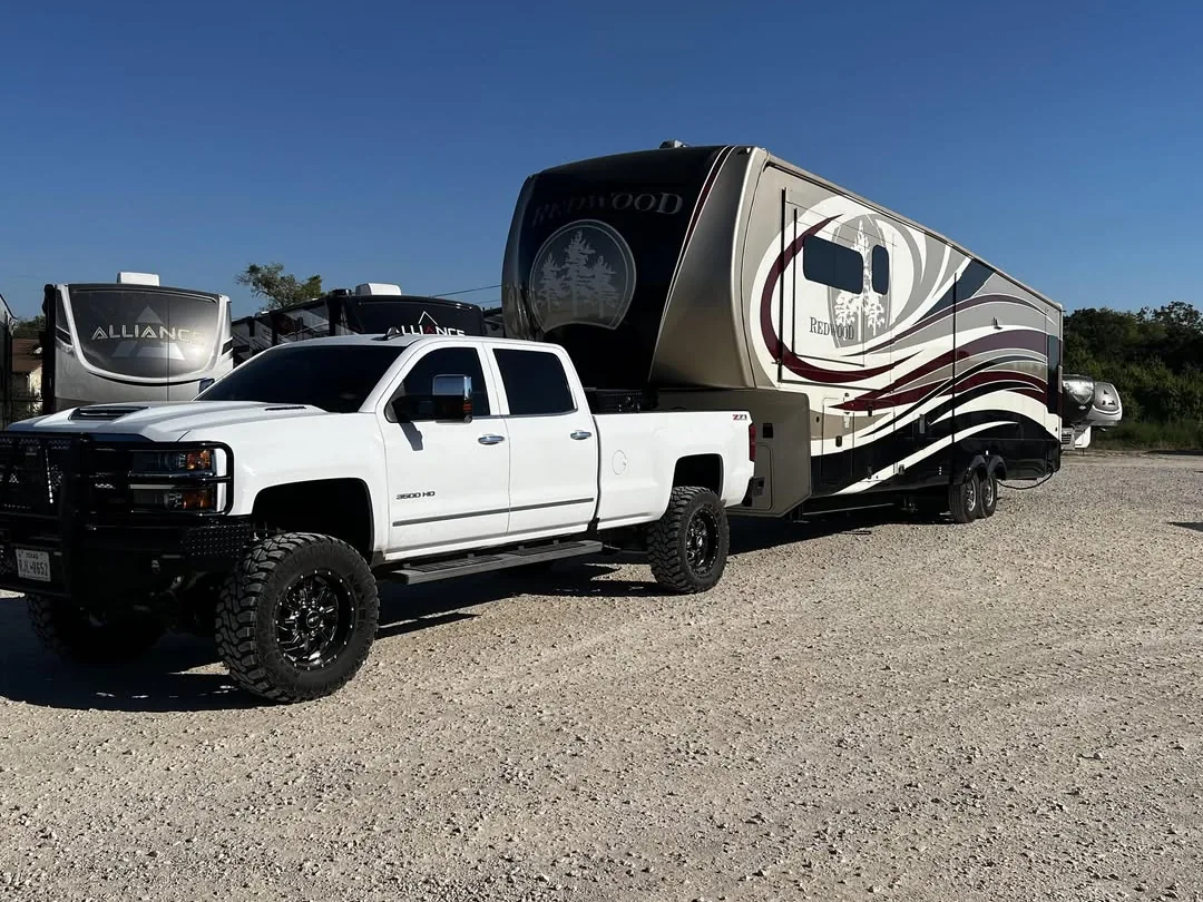 Fifth wheel hitched to a pickup at the shop, RV suspension repair