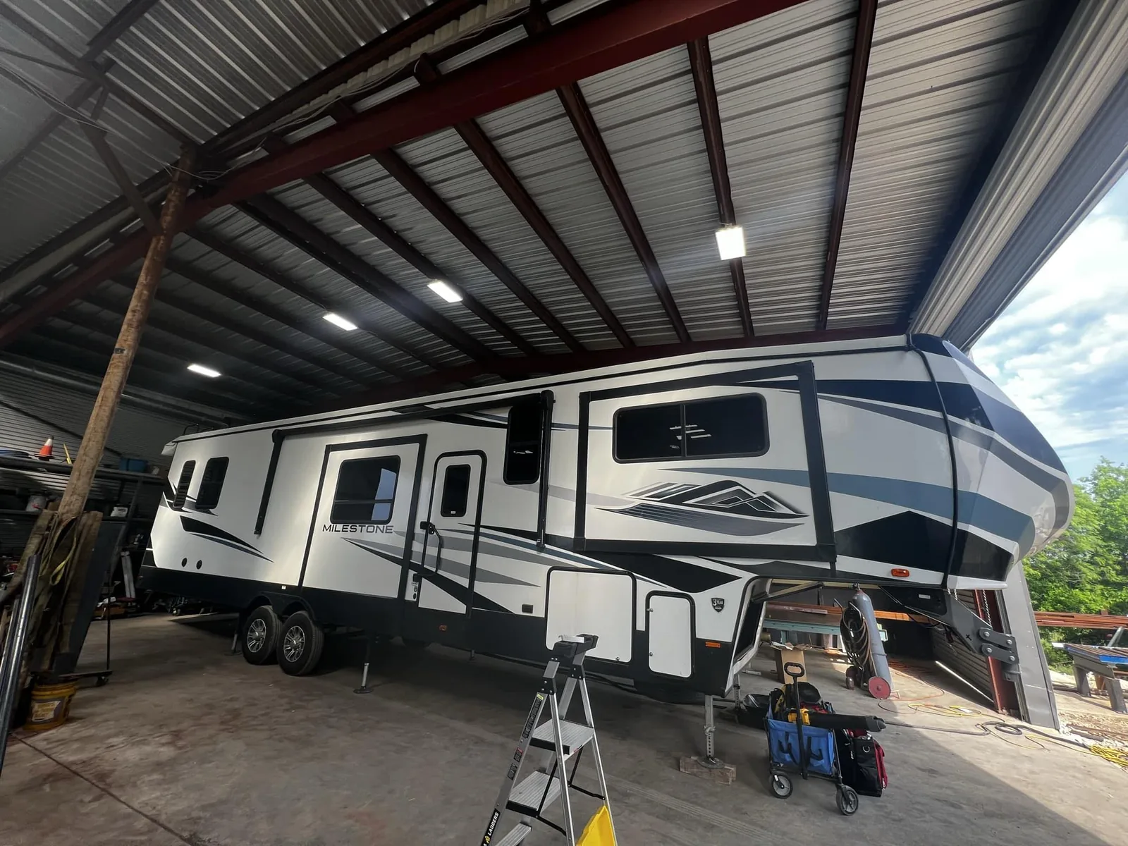Fifth wheel inside the San Marcos shop bay, RV warranty and insurance repairs