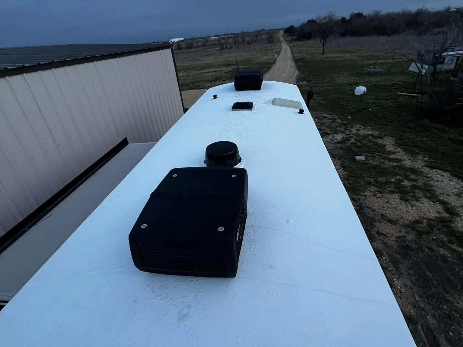 Finished white roof on a travel trailer after a covered repair, RV warranty and insurance repairs