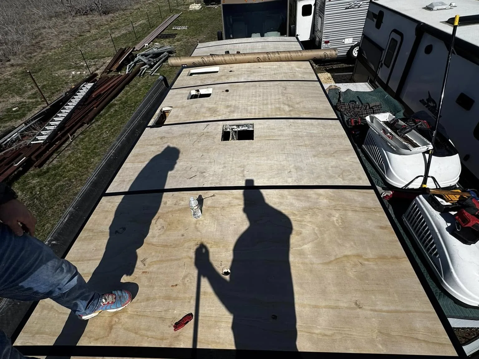 Technician on new roof decking during an insurance roof replacement, RV warranty and insurance repairs
